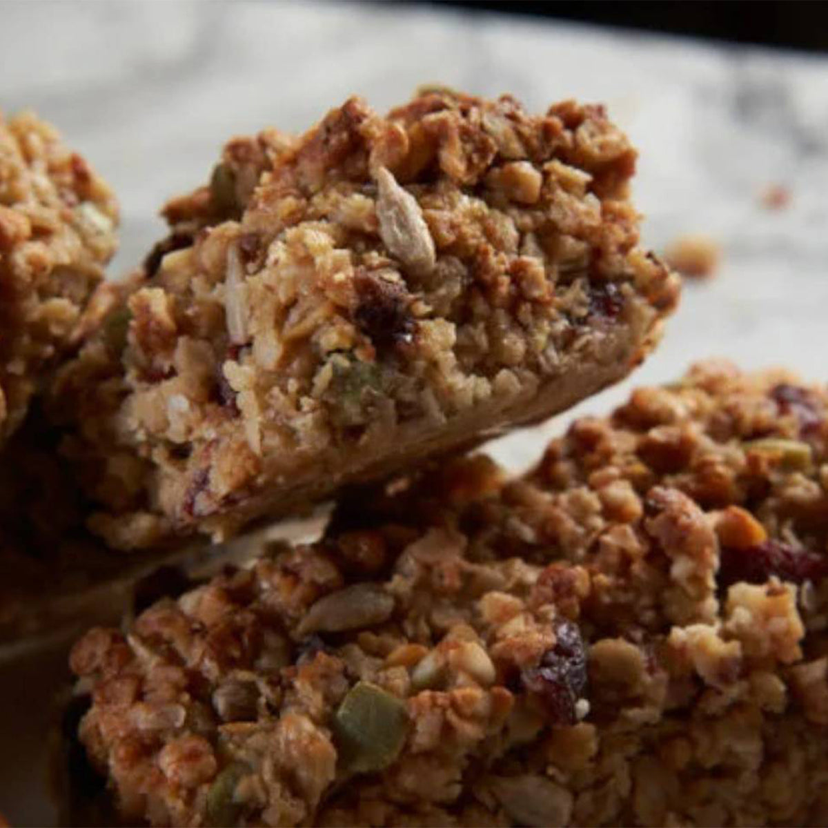 Mena Protein Bars made with oats, seeds, and dried fruit.