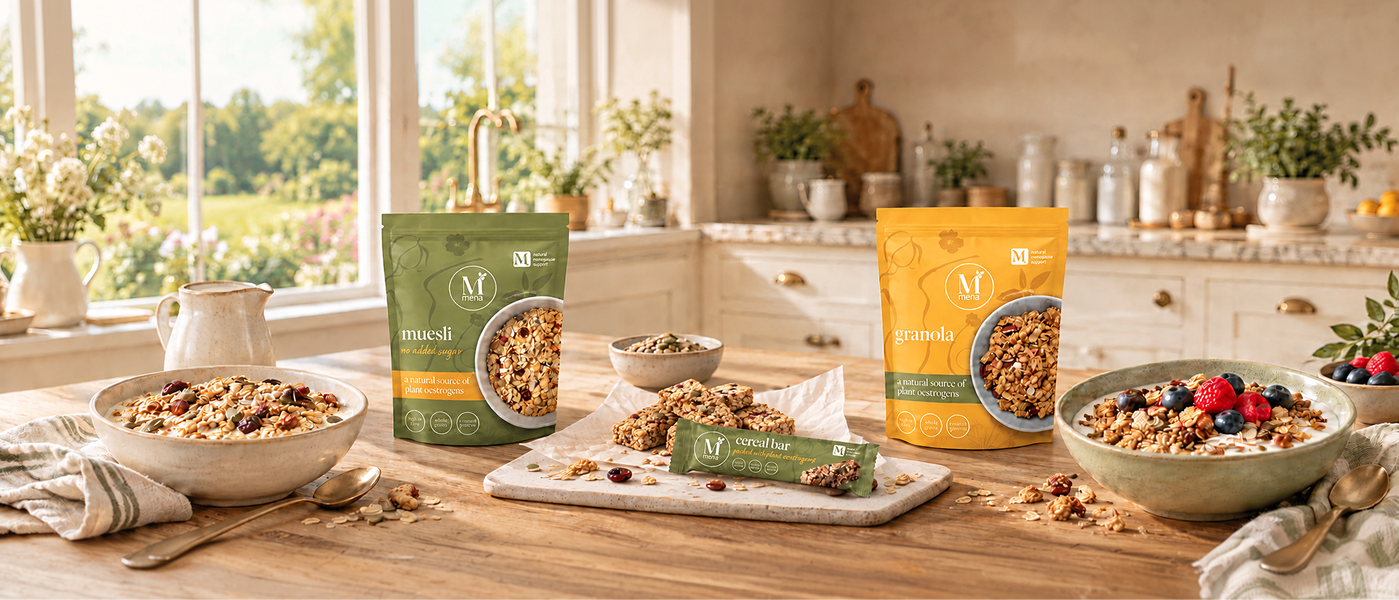 Mena Pause muesli, granola, and cereal bar packages on a wooden kitchen counter.